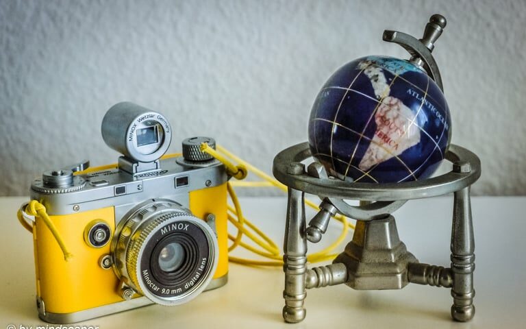 Geotagging: Yellow Vintage Camera And Blue Globe